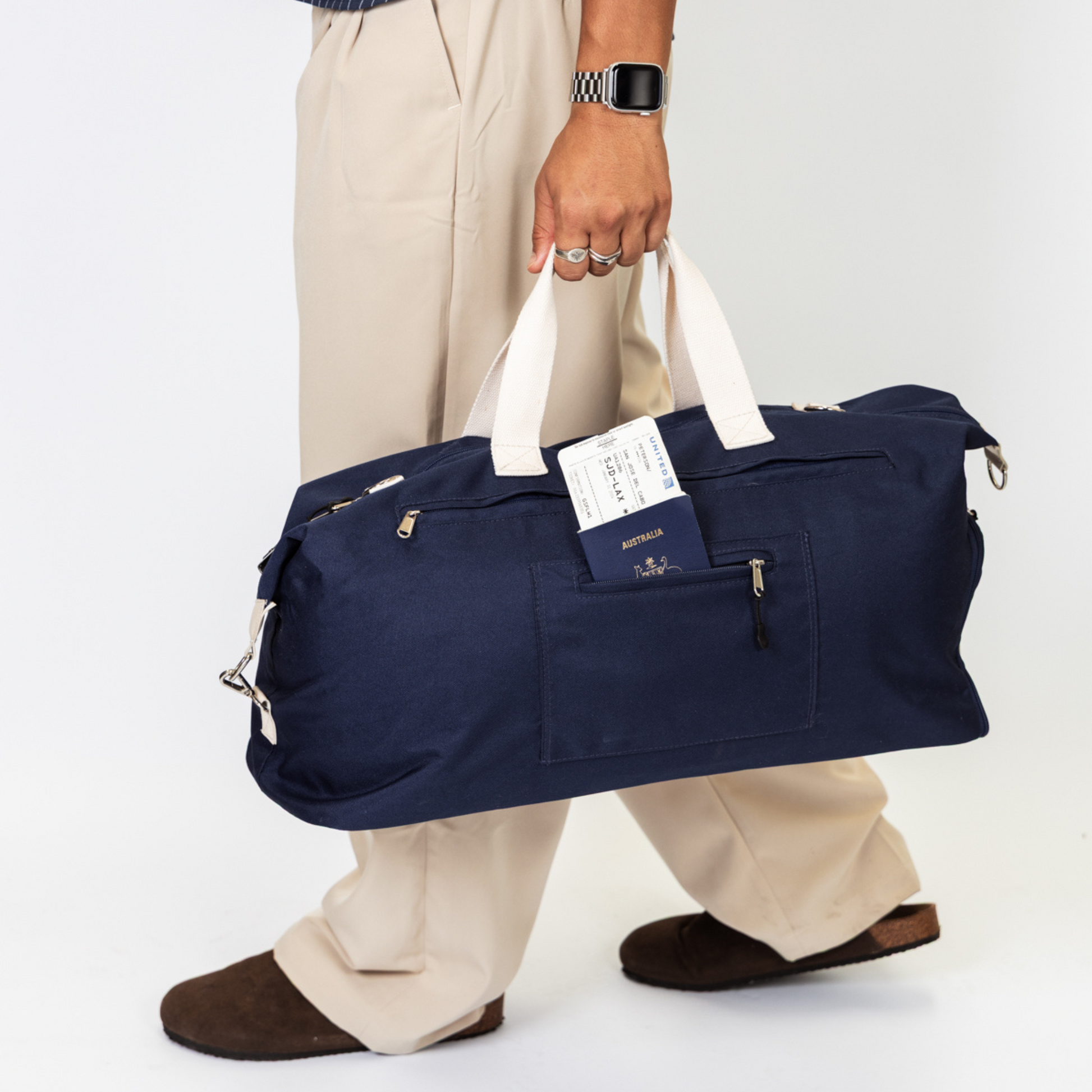 Navy duffle bag in transit with secret passport pocket