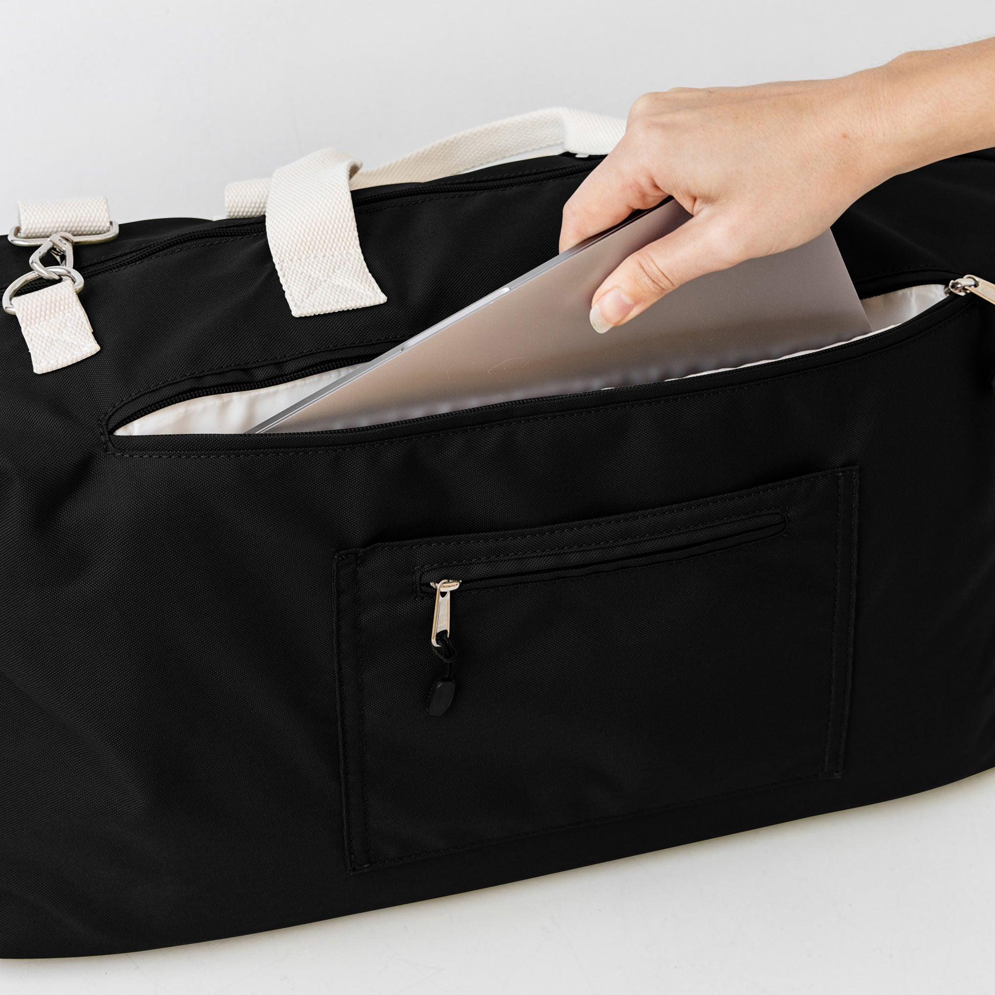 Black duffle bag back with padded laptop section and luggage passthrough