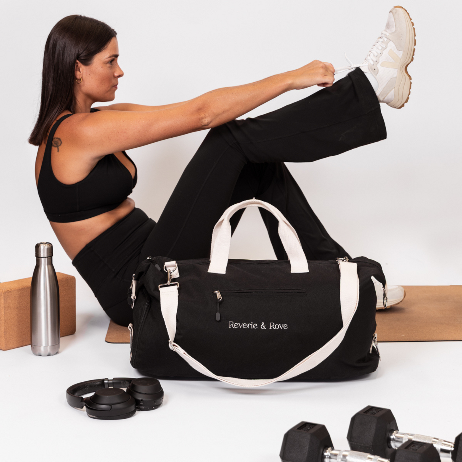 Black duffle bag packed for gym with accessories