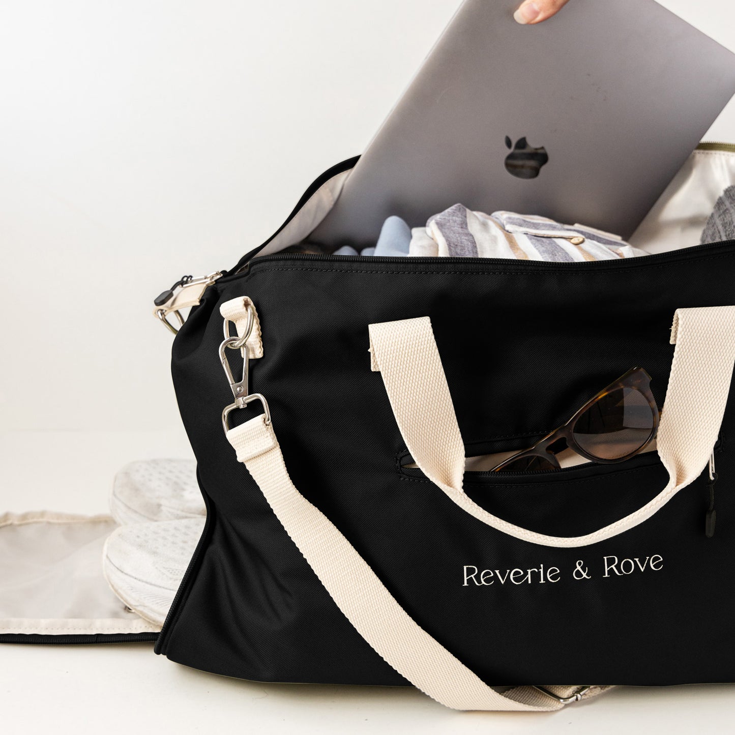 Black duffle bag packed for working holiday showing multiple features