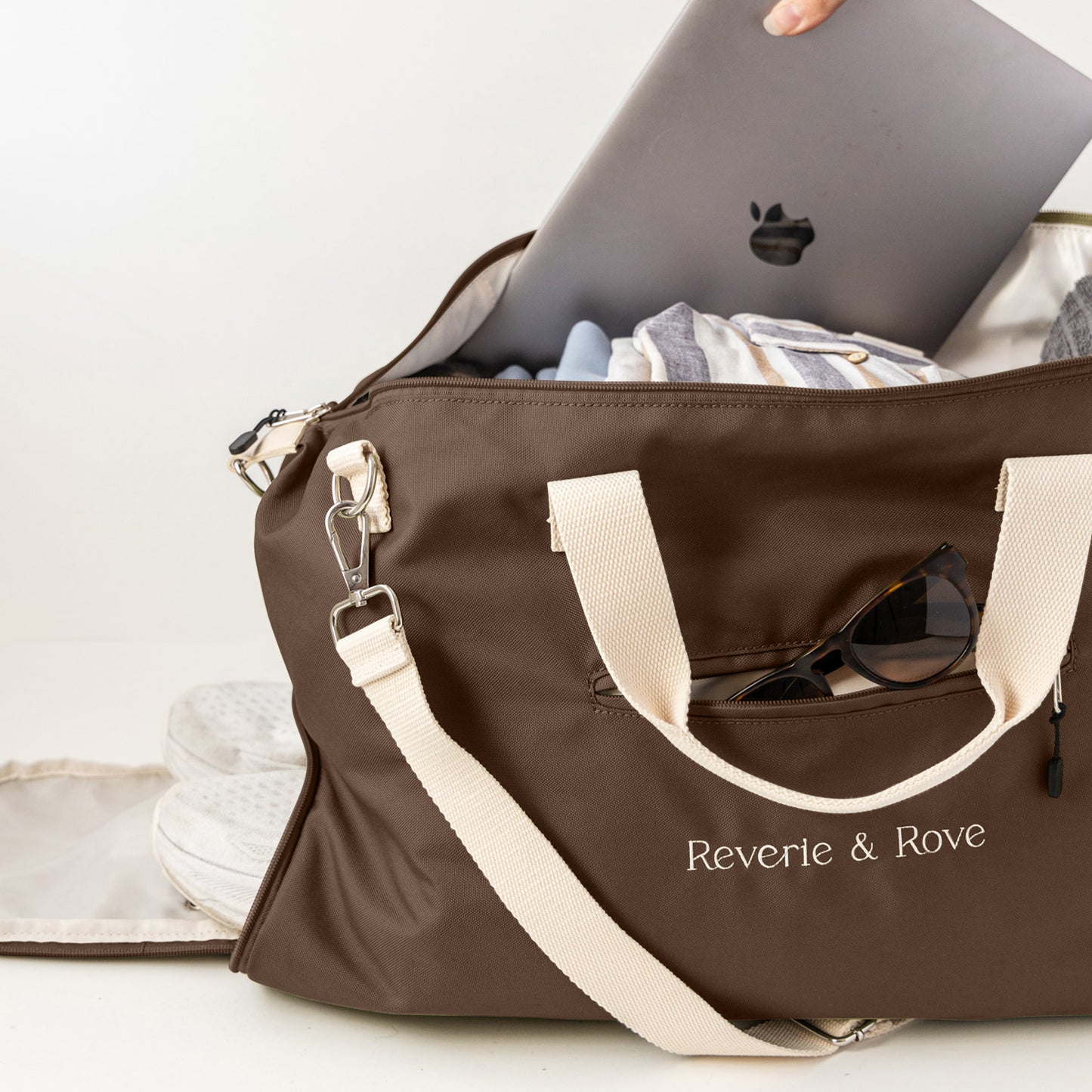 Chocolate duffle bag pack for work and travel showing multiple features