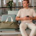 Duffle bag with male model at airport